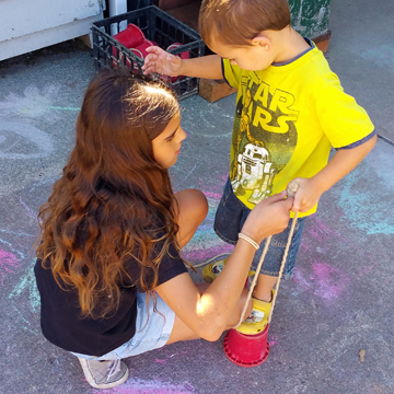 Girl helping little boy